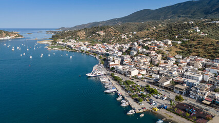 Aerial panorama of the city and harbor of Poros island in the Saronic Gulf, Greece, during a colorful summer sunset