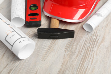 Building level and other construction tools on white wooden table, closeup. Space for text