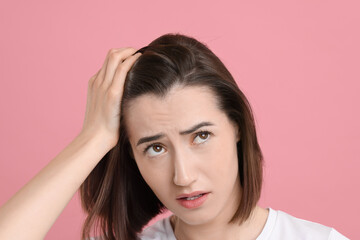 Fototapeta premium Sad woman with hair loss problem on pink background, closeup