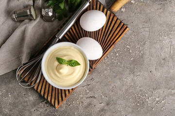 Bowl of fresh mayonnaise on grey background