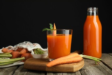 Healthy juice and fresh carrot on wooden table
