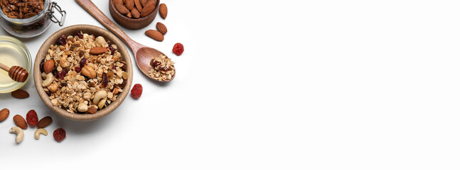 Granola served with honey, nuts and dried fruits on white table, flat lay. Banner design with space for text