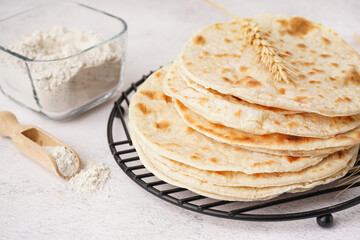 Grid of tasty pita bread on white background