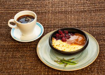 Blackberry dessert with fried cheese and caramel sauce - Typical Colombian gastronomy. Coffee hot drink