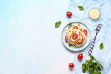 Plate with tasty pasta primavera on blue background