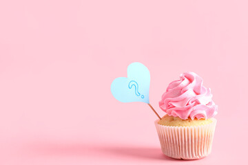 Delicious cupcake with question mark on color background. Gender reveal party concept