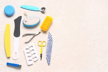 Set of professional tools for pedicure on textured white background