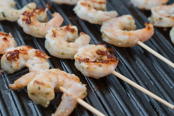 Close-Up of Shrimp Skewers Cooking on a Grill Pan