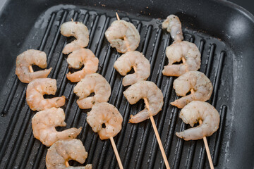 Close-Up of Shrimp Skewers Cooking on a Grill Pan