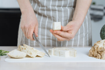 Woman cutting celeriac into cubes