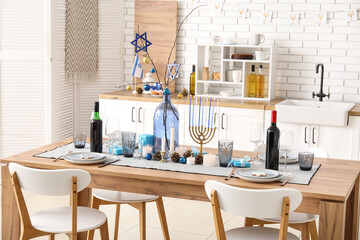 Festive table setting with Hanukkah decorations in kitchen