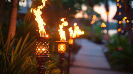 The warm glow of tiki torches illuminating the pathway to the movie night guiding guests to their seats.
