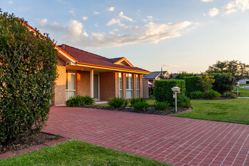 Last sunset light on brick house in quiet suburban area