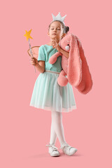 Thoughtful little fairy with wand with toy bunny on pink background