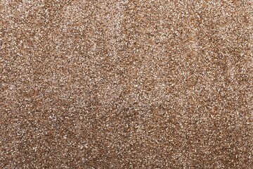 Shiny light brown glitter as background, closeup