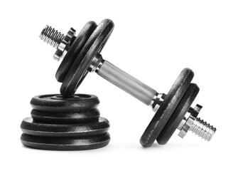 Barbell and stack of weight plates isolated on white