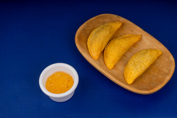 Colombian empanada with spicy sauce 