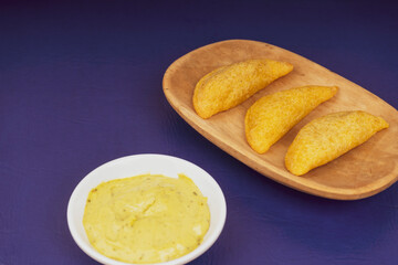 Delicious traditional Colombian empanadas with spicy sauce