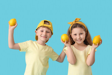 Cute children with lemons on blue background