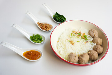 Bakso Meatballs and Rice Noodles with Soup Served Chili Sauce, Indonesia Food Style Popular Street Food served on bowl with chili sauce, chopped celery and fried onions sideview