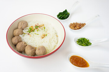 Bakso Meatballs and Rice Noodles with Soup Served Chili Sauce, Indonesia Food Style Popular Street Food served on bowl with chili sauce, chopped celery and fried onions sideview
