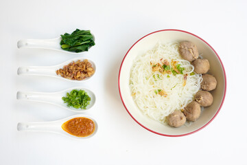 Bakso Meatballs and Rice Noodles with Soup Served Chili Sauce, Indonesia Food Style Popular Street Food served on bowl with chili sauce, chopped celery and fried onions sideview