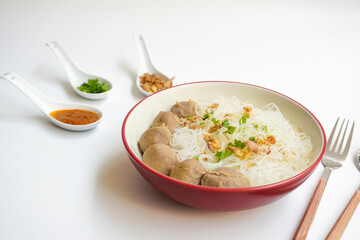 Bakso Meatballs and Rice Noodles with Soup Served Chili Sauce, Indonesia Food Style Popular Street Food served on bowl with chili sauce, chopped celery and fried onions sideview