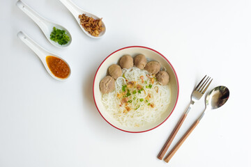 Bakso Meatballs and Rice Noodles with Soup Served Chili Sauce, Indonesia Food Style Popular Street Food served on bowl with chili sauce, chopped celery and fried onions sideview