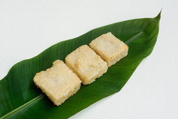 Jadah or Uli Ketan or ulen ketan goreng is a traditional Indonesian food made from sticky rice and grated coconut, fried on pan. Usually served as a tea time snack. Served on banana leaf