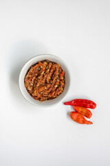 Indonesia traditional cuisine sambal bawang or spicy garlic chili sauce served on a white bowl isolated on white background.