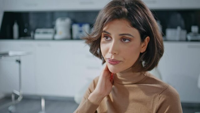 Medicare patient complaining pain in medical office closeup. Woman in clinic