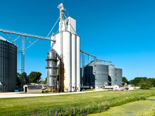 Large Agricultural Grain Elevator and Silos situated along the Illinois and Michigan Canal. Clear blue skies overhead.