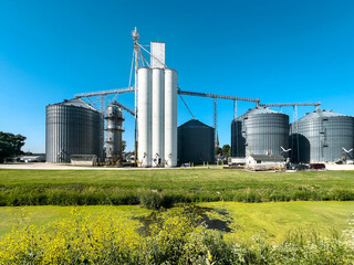 Large Agricultural Grain Elevator and Silos situated along the Illinois and Michigan Canal. Clear blue skies overhead.