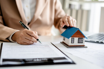 Female Real Estate Broker presenting and advised to .model home and building project detail in the...