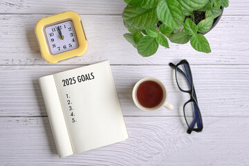 2025 goals on notepad, top view. 2025 new year goals, plan and action concept.