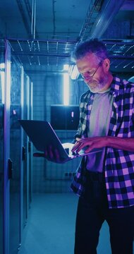 IT Server Technician Wearing Glasses Staring at Neon Display
