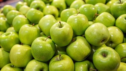juicy group green apples in the supermarket. sold in market  supermarket. a pile of fresh green apples neatly arranged in a fruit shop  fruits background concept