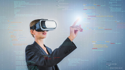 Project manager coding engineering prompt while using VR glasses. Skilled businesswoman pointing...