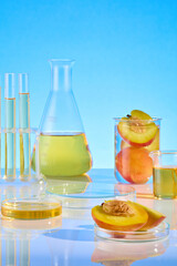 Blue background photo was taken from front angle, blank showcase podium of glass displayed in center for showing cosmetic product, which made from peach ingredient. Blank space for advertising