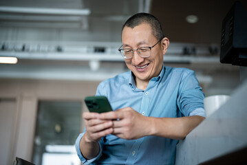 businessman using mobile phone in open office