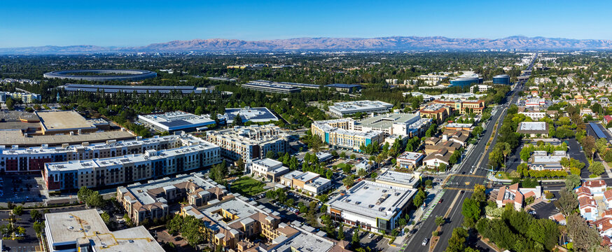 Aerial panoramic view of Main Street Cupertino residential and commercial neighborhood in San Francisco Bay Area, California. Silicon Valley skyline