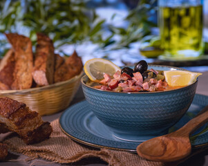 Photo of food, solyanka soup in a beautiful plate in rustic style. Homemade bread fried with spices. Unusual background. Homemade food. Restaurant menu.
