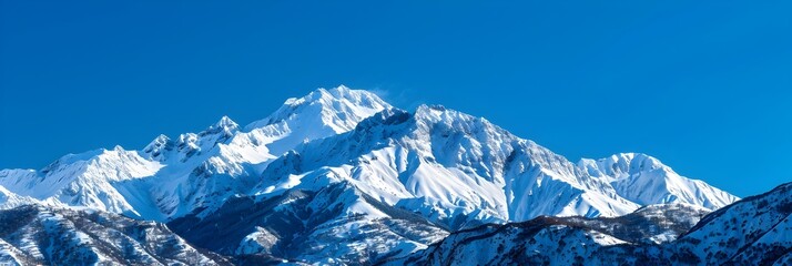 Majestic Snow Capped Mountain Peaks under Cloudless Blue Sky