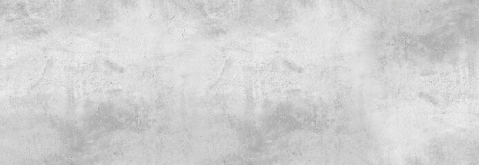 Large white grunge textured concrete wall background. The backdrop is a rough cement floor in gray tones.