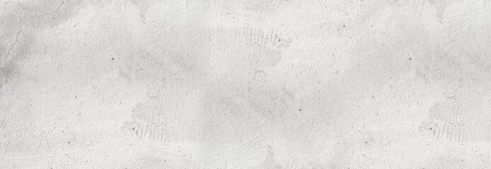 Large white grunge textured concrete wall background. The backdrop is a rough cement floor in gray and white tones.