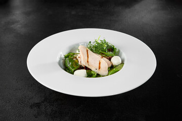 Fresh Chicken Fillet and Mozzarella Salad on a White Plate in Fine Dining Setting