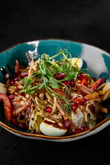Fresh Salad with Tongue, Pomegranate, and Vegetables in a Rustic Bowl