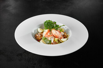 Delicious Crab Salad with Egg and Fresh Vegetables on a White Plate
