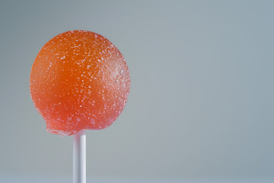 orange Lollipop on White Background
