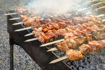 A grill with meat on it and a lot of smoke coming out of it